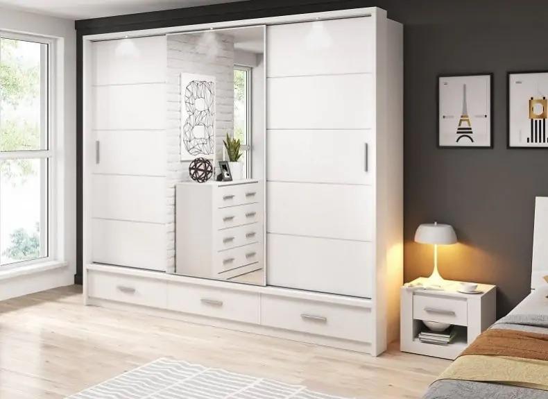 White sliding-door wardrobe with a central mirrored panel and built-in drawers, styled in a modern bedroom with neutral décor and bedside table.